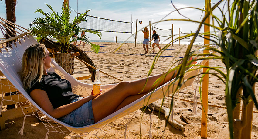  Girl lying in hammock on the beach