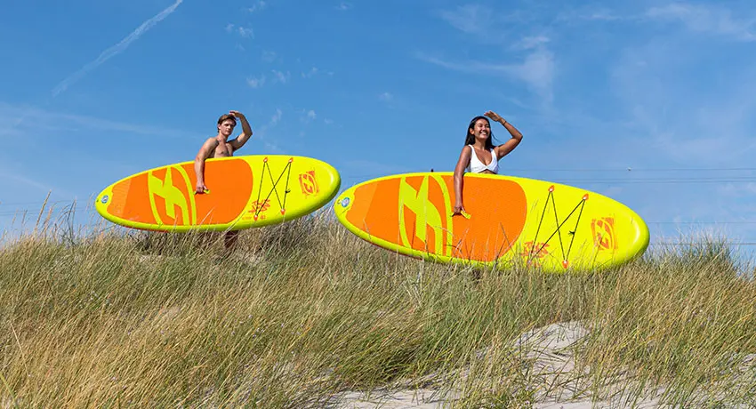  Two people with SUP boards