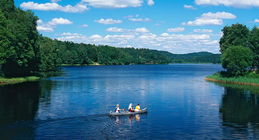  Three people canoe in the lake Gyltigesjön