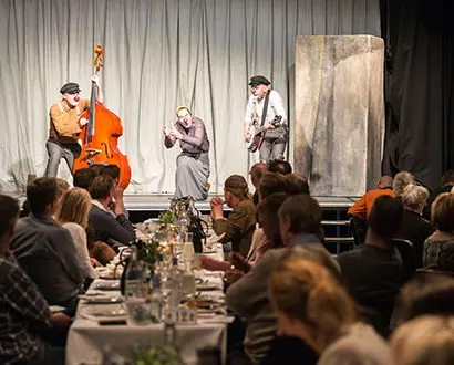  Clowns on stage at Halmstad Theatre. The audience sits at the table and eats.